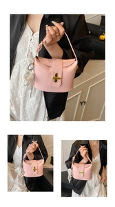 Detailed macro view of pink litchi grain leather handbag with gold clasp and pearl lace charm