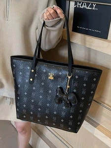 Classic black tote bag with bear pattern print, gold metal plaque and leather charm