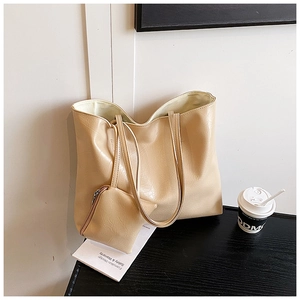 Detail of soft cream large tote bag and matching zipper pouch in a daily scene