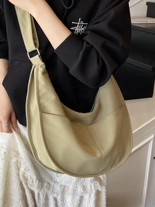 Minimalist khakis green crescent crossbody bag with wide strap and canvas texture