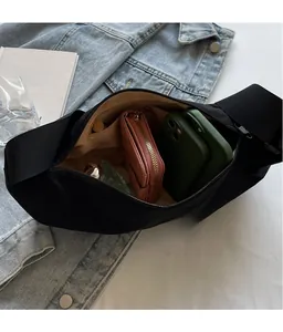 Interior view of black nylon crossbody bag showing spacious capacity and zipper pocket