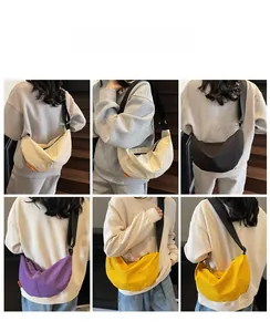 Detail view of stylish dumpling crossbody bags in four colors on an adjustable strap