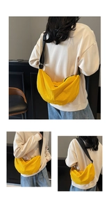 Detail of a bright yellow crescent nylon crossbody bag featuring black adjustable wide strap