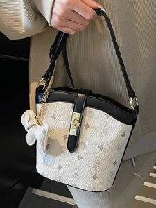 Classic bucket bag in white bear print with black trim and gold hardware accents