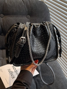 Chic black woven texture bucket bag with silver chain strap and shiny pleated finish