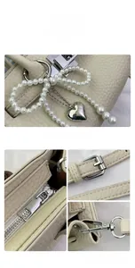 Detailed close-up of litchi grain leather texture with pearl bow and silver hardware charms