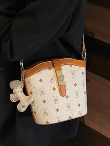Classic printed bucket bag in beige leather with bear pattern and brown shoulder strap