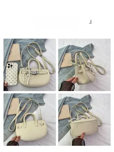 Detail views of cream bucket bag with lychee texture and pearl bow charm from four angles