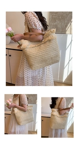 Detailed macro view of woven straw tote bag with fringe trim and brown leather handles