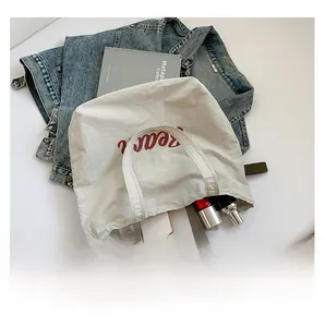 Spacious tote bag interior showing capacity for phone, cosmetics, and notebooks