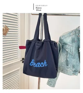 Detail view of navy blue tote bag with Beach print and practical drawstring closure