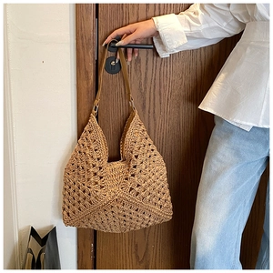 Gros plan sur le motif crochet ajouré et la bandoulière en cuir du sac cabas