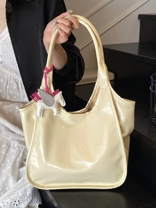Cream oil-wax leather tote bag with glossy finish and pegasus charm for women