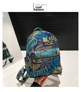 Detail view of the tropical leaf print backpack showing side pockets and carrying handle