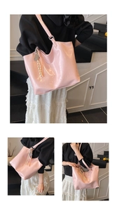 Macro detail of glossy pink leather tote bag featuring embossed brand logo and texture