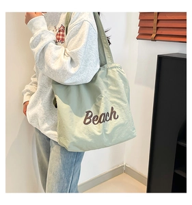 Close-up of mint green tote bag featuring Beach print on casual fabric material