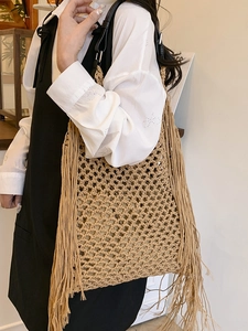 Minimalist hand-woven crochet tote bag with khaki fringe and black leather straps