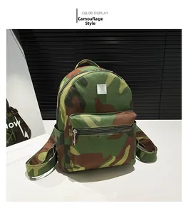 Detail of green camouflage canvas backpack with zipper pocket and silver tag