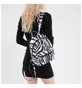Close-up of zebra print fashion backpack showing textured fabric and adjustable straps