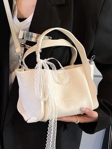 Minimalist cream bucket bag with lacy ribbon detail and embossed texture for women