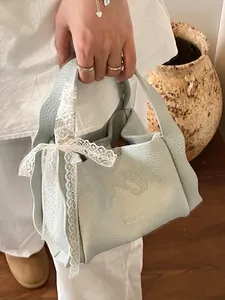 Minimalist light blue lychee pattern leather bucket bag with a white lace bow detail