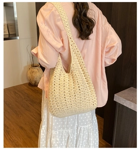 Detailed close-up of a cream woven tote bag showing hollow crochet texture and boho style