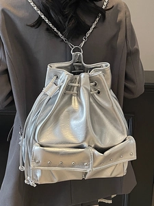 Silver metallic drawstring bucket backpack with chain straps and tassel details for women