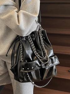 Fashionable black faux leather bucket bag with silver chains and metallic rivets detail