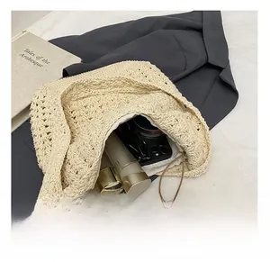 Detail view of the beige hollow knit tote bag showing spacious internal capacity and soft texture