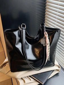 Minimalist black shiny oil-wax leather tote bag with a tennis racket charm and Logo