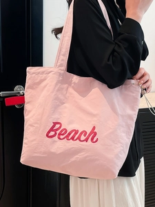 Pink nylon tote bag with red Beach embroidery and side drawstring for women