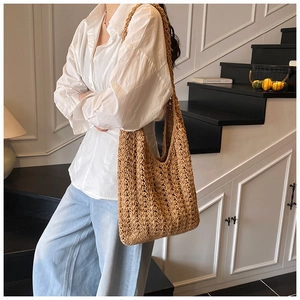 Close-up of woven hollow knit tote bag with intricate wavy texture and natural finish