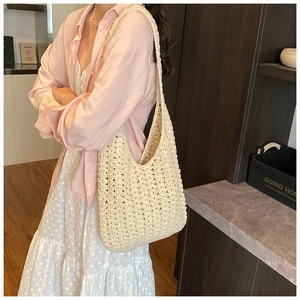 Detail view of cream crochet tote bag featuring intricate honeycomb hollow weave pattern