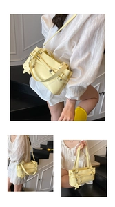 Detail of French vintage crossbody bag in pale yellow leather with star charm
