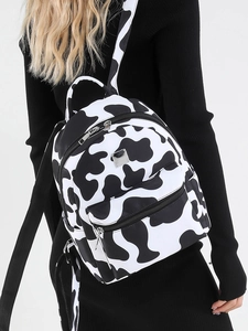 Stylish cow print backpack for women featuring black and white pattern and front pocket