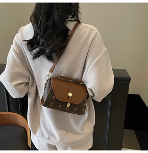 Detailed view of vintage crossbody bag with classic brown monogram print and top handle