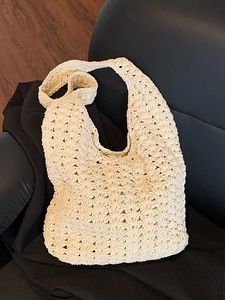 Minimalist cream crochet woven tote bag featuring hollow patterns for beach vacations