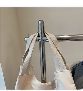 Detail of the reinforced wide handle and neat stitching on this beige canvas tote bag