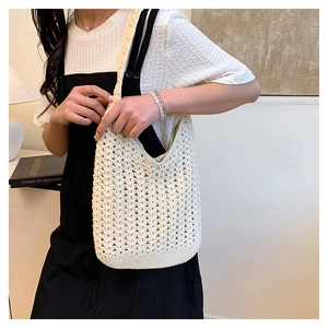 Detail of handwoven crochet tote bag showing the geometric hollow mesh pattern and texture