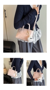 Close-up of pink leather bucket bag with cute white plush monster charm and embossed logo