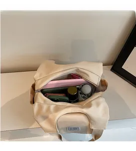 Spacious interior of beige tote bag showing tablet, umbrella, and daily essentials