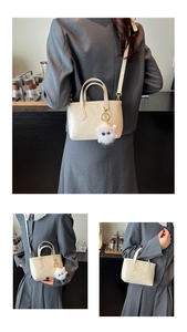 Detailed views of a minimalist beige bucket bag with plush charm and long strap