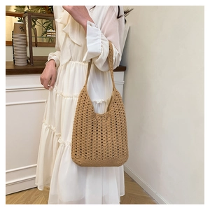 Detail of hand-woven crochet tote bag in khaki with hollow out knit pattern