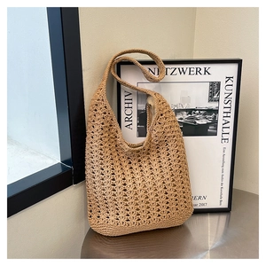 Detailed close-up of light khaki crochet texture on a bohemian beach tote shoulder bag