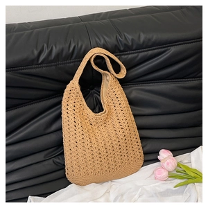 Detail of crochet tote bag showing hollow weave texture, khaki color and fabric lining