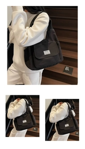 Detailed views of a large black canvas tote bag with front pocket and white brand label