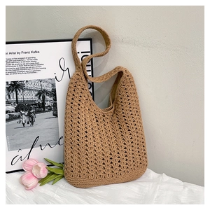 Detailed close-up of khaki crochet hobo bag texture with intricate woven hollow patterns