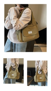 Detail view of olive green canvas tote bag showing side pockets and adjustable strap