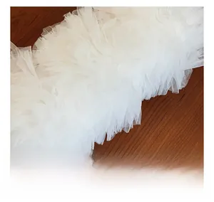 Macro shot of elegant white pleated lace mesh fabric with soft ruffled texture details