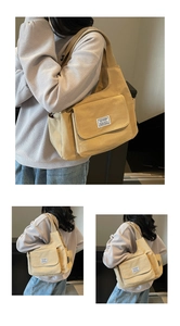 Close-up of khaki canvas shoulder bag showing front flap pocket and CHUANGMI brand label